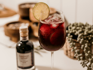 Guests enjoying a local gin tasting experience on Kangaroo Island, sampling handcrafted spirits made with native botanicals, surrounded by the cozy atmosphere of a rustic distillery.